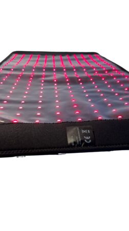 WAVE RLT G42 Light Therapy Mat in Large shown lit with bright red light on white background